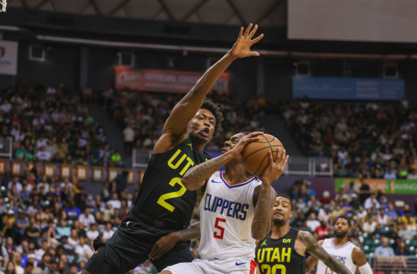 HONOLULU, HAWAII - OCTOBER 8: Bones Hyland #5 of the Los Angeles Clippers drives to the basket against Collin Sexton #2 of the Utah Jazz during the first half of the preseason game at SimpliFi Arena at the Stan Sheriff Center on October 8, 2023 in Honolulu, Hawaii. NOTE TO USER: User expressly acknowledges and agrees that, by downloading and or using this photograph, User is consenting to the terms and conditions of the Getty Images License Agreement. (Photo by Darryl Oumi/Getty Images)